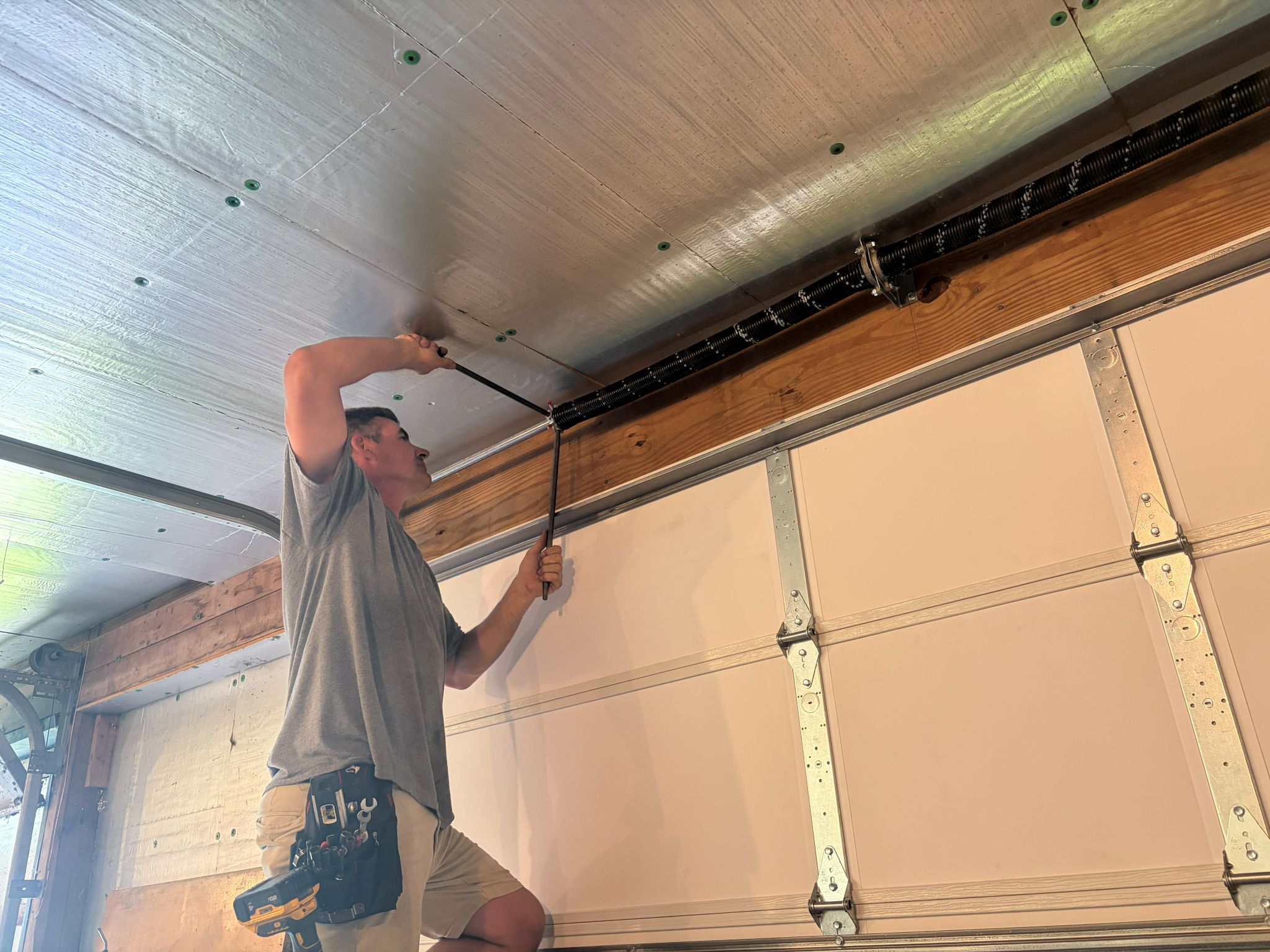 Larry tightening garage spring